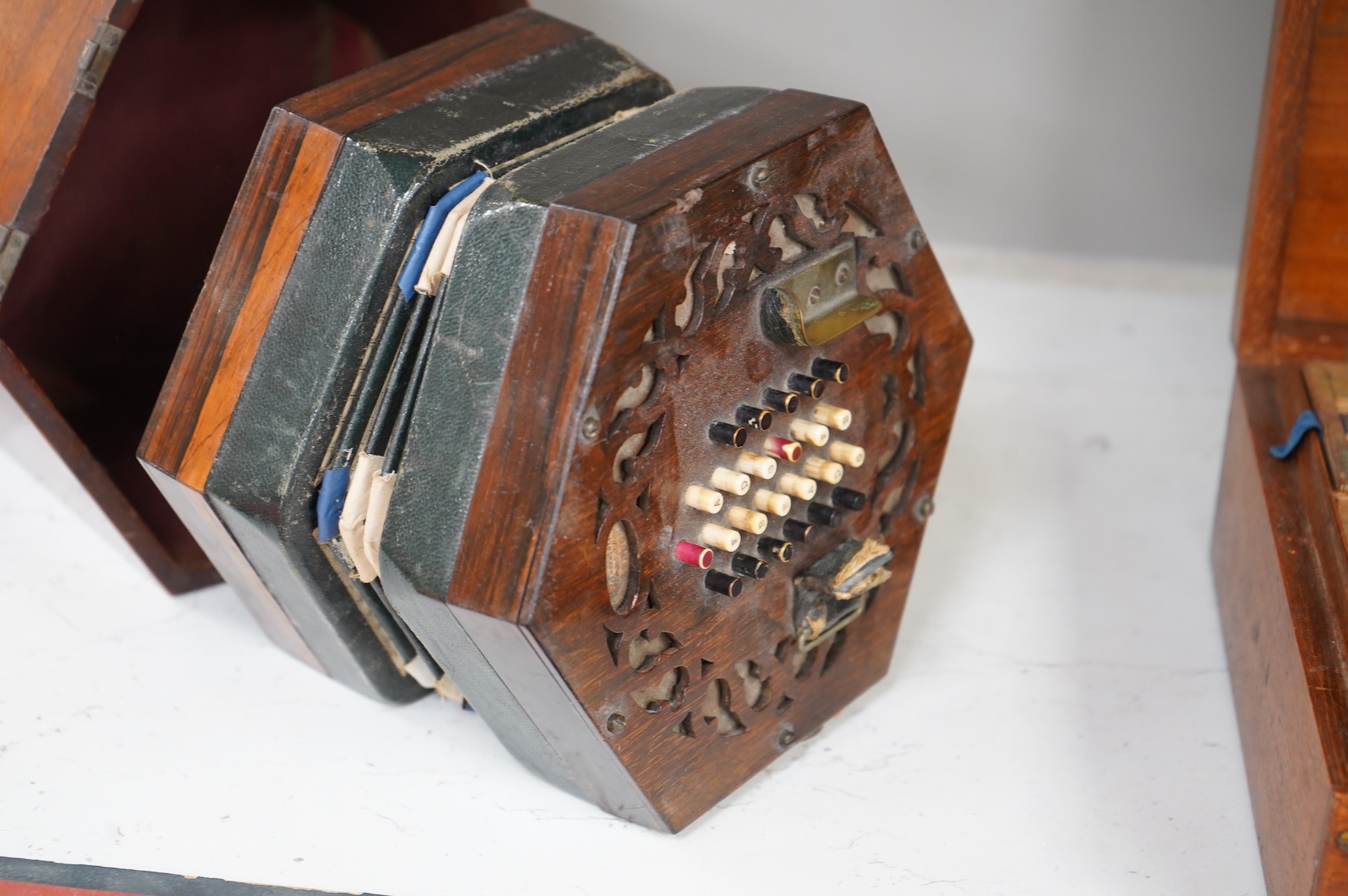 A Wheatstone mahogany cased 48 key rosewood and leather and paper bellows concertina, 18cm wide